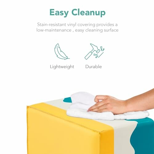 Hand cleaning a yellow and white vinyl cube, highlighting easy cleanup, lightweight, and durable features.